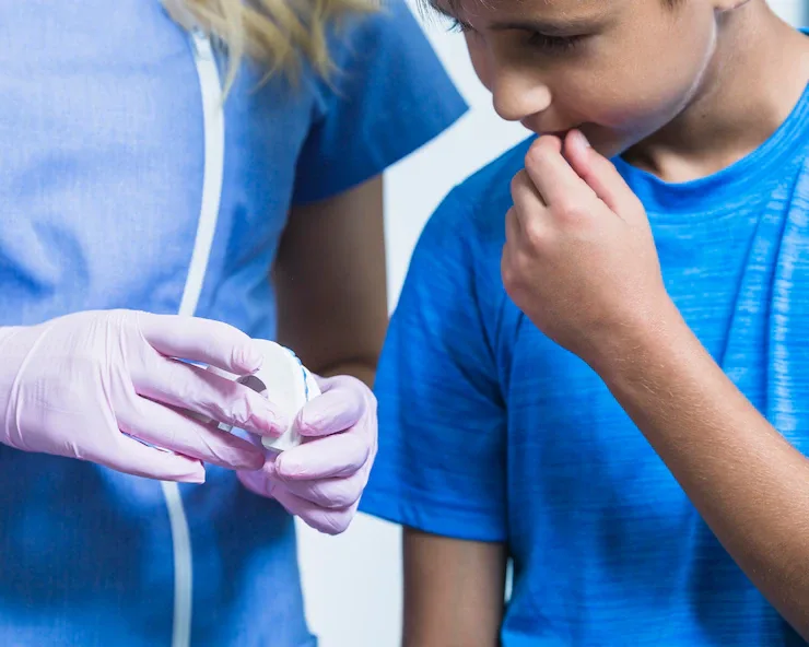 Orthodontist fitting a clear aligner for a young patient