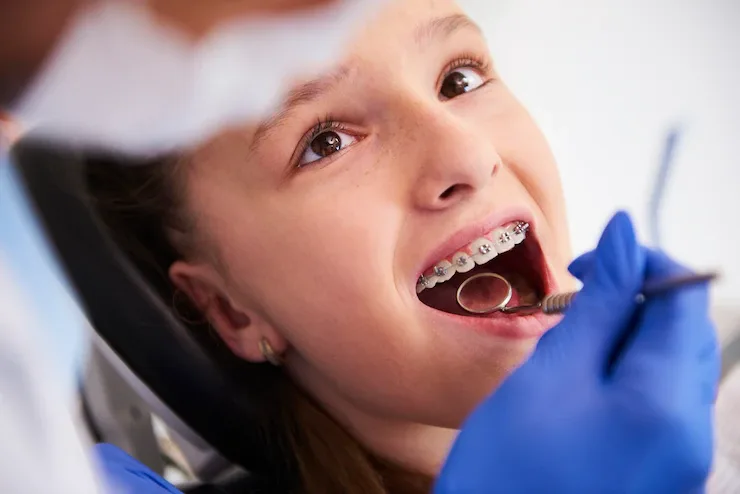 Smiling girl with braces during a check-up