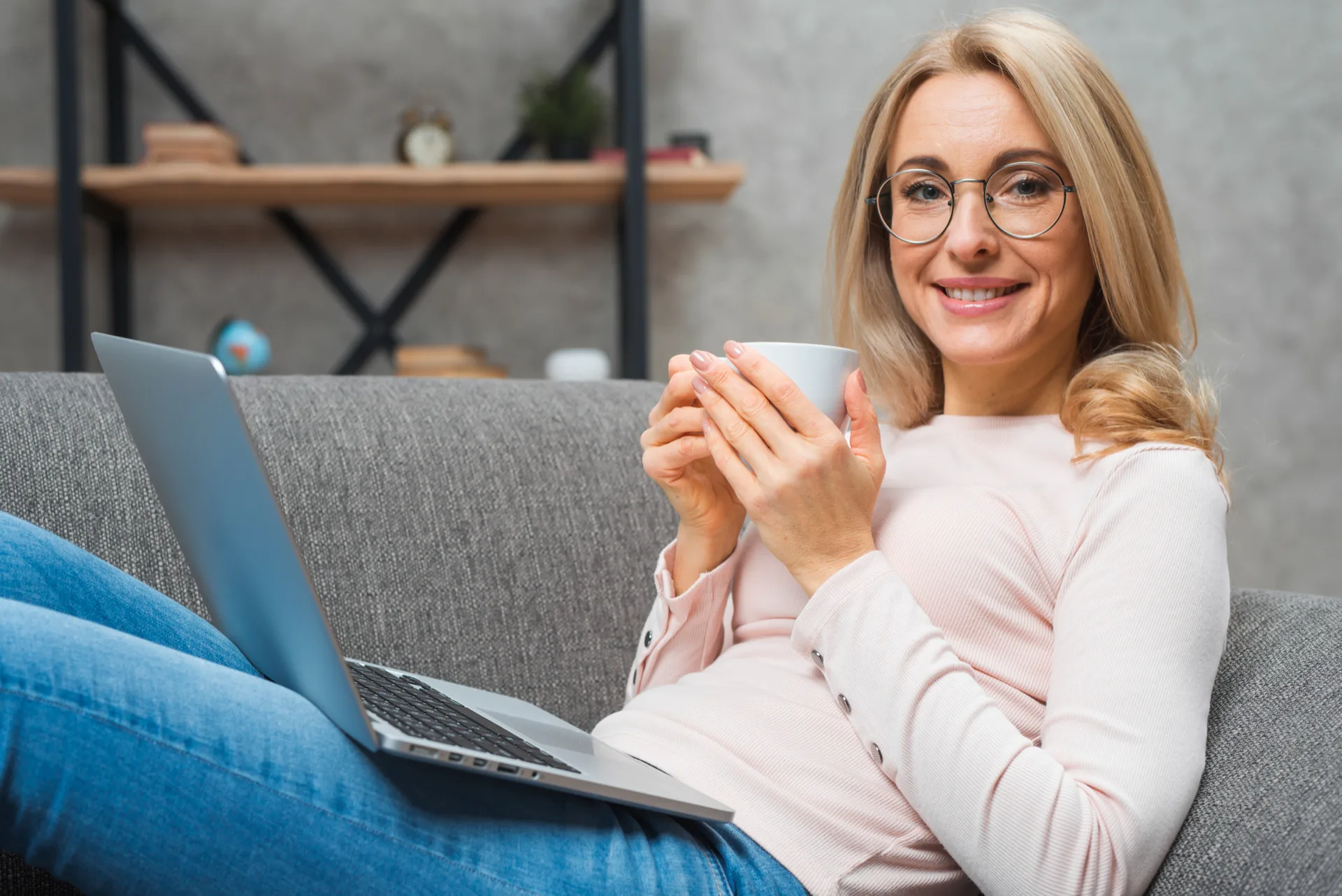 Smiling woman relaxing with a cup of tea
